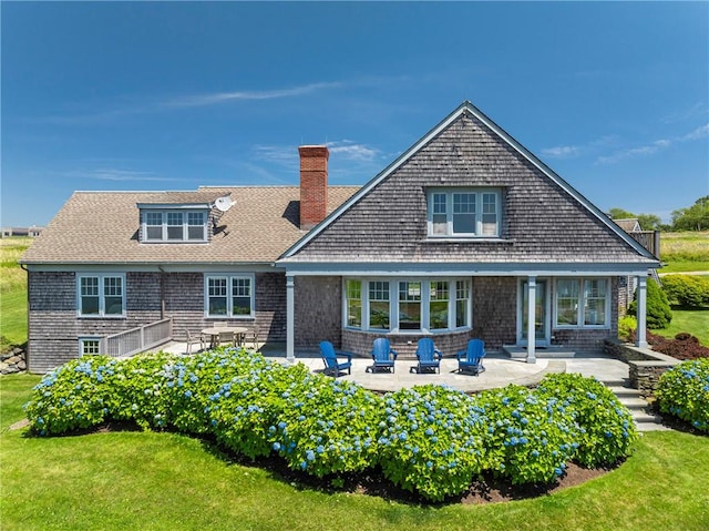 17 Ferolbink Way, Little Compton, RI 02837 - back of house with a patio, a chimney, and a lawn