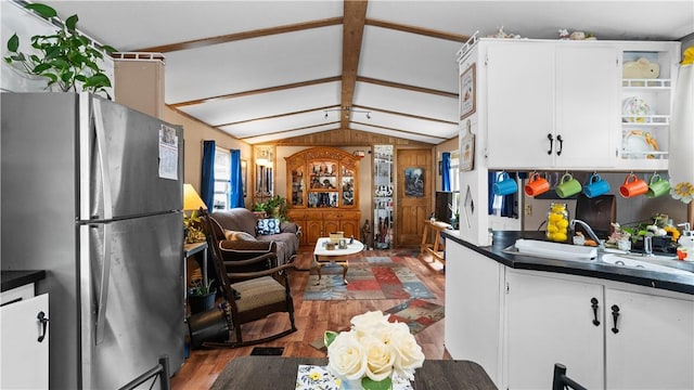 245 Manton St, Pawtucket, RI 02861 - kitchen with freestanding refrigerator, open shelves, light wood-style floors, dark countertops, and white cabinetry