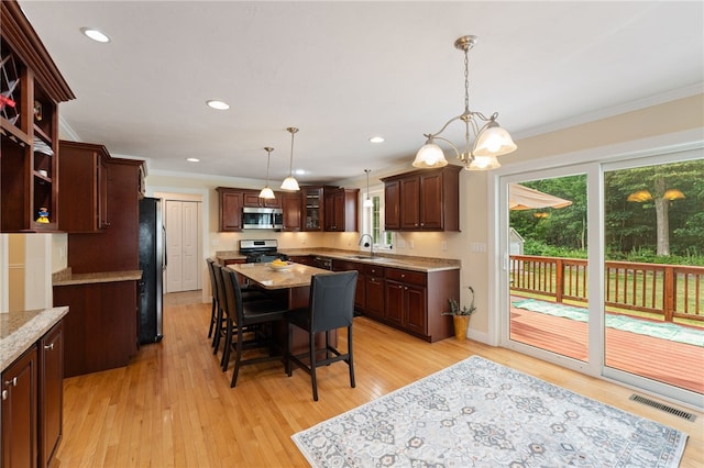 10 Sables Way, Lincoln, RI 02865 - kitchen with appliances with stainless steel finishes, ornamental molding, a kitchen island, light wood finished floors, and a chandelier