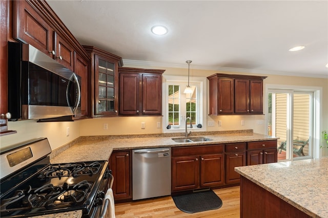 10 Sables Way, Lincoln, RI 02865 - kitchen with appliances with stainless steel finishes, pendant lighting, light stone countertops, crown molding, and glass insert cabinets
