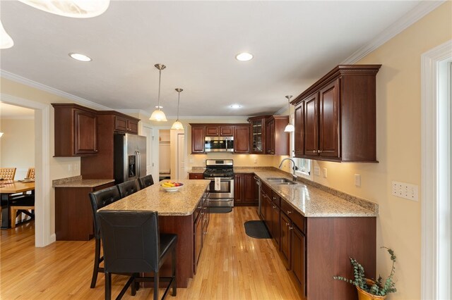 10 Sables Way, Lincoln, RI 02865 - kitchen featuring appliances with stainless steel finishes, a breakfast bar, light wood finished floors, a kitchen island, and pendant lighting