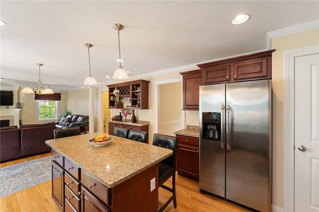 10 Sables Way, Lincoln, RI 02865 - kitchen with stainless steel fridge, light wood finished floors, a kitchen island, crown molding, and a breakfast bar area