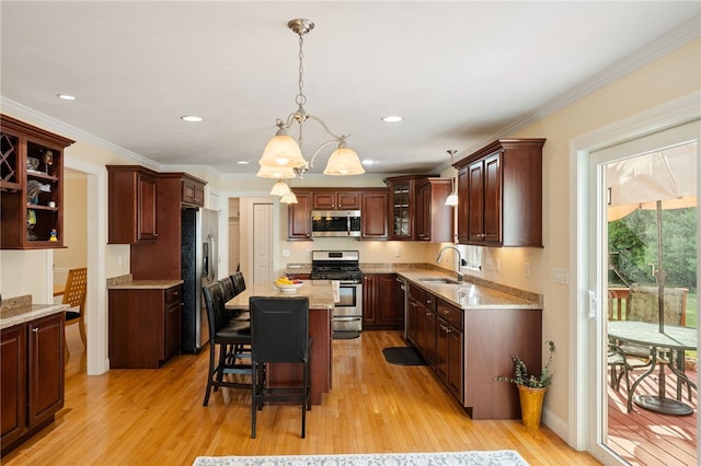 10 Sables Way, Lincoln, RI 02865 - kitchen with appliances with stainless steel finishes, a chandelier, light wood-style floors, a center island, and a kitchen breakfast bar