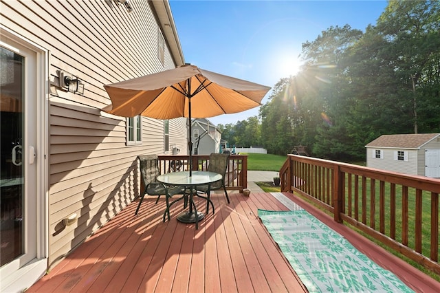 10 Sables Way, Lincoln, RI 02865 - wooden terrace featuring a lawn, outdoor dining area, and a storage shed