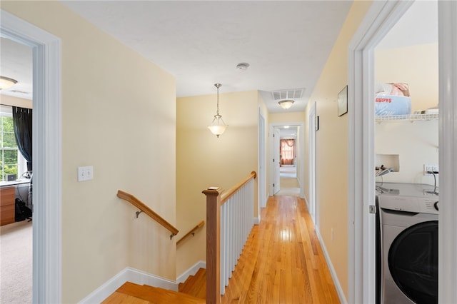 10 Sables Way, Lincoln, RI 02865 - hallway with washer / dryer, an upstairs landing, and light wood-style flooring