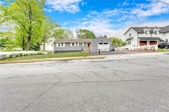 1463 Broadway Way E, Providence, RI 02914 - view of front of property with a garage, asphalt driveway, a fenced front yard, and an outdoor structure