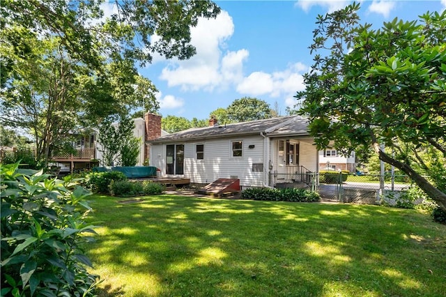55 Wayland Trl, Narragansett, RI 02882 - rear view of property with a chimney and a wooden deck