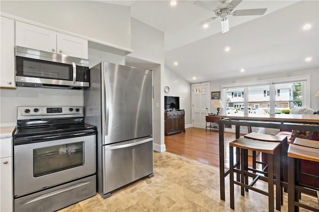55 Wayland Trl, Narragansett, RI 02882 - kitchen featuring stainless steel appliances, white cabinetry, ceiling fan, light countertops, and vaulted ceiling