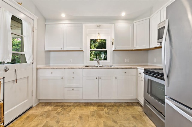 55 Wayland Trl, Narragansett, RI 02882 - kitchen with stainless steel appliances, white cabinetry, light countertops, healthy amount of natural light, and recessed lighting