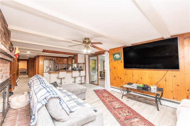 584 Division Rd, East Greenwich, RI 02818 - living room featuring wooden walls, beamed ceiling, a ceiling fan, a brick fireplace, and light wood finished floors