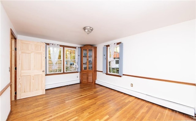 584 Division Rd, East Greenwich, RI 02818 - unfurnished room featuring a baseboard radiator, light wood-style floors, and plenty of natural light
