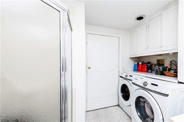 584 Division Rd, East Greenwich, RI 02818 - laundry area featuring separate washer and dryer, cabinet space, and light tile patterned floors