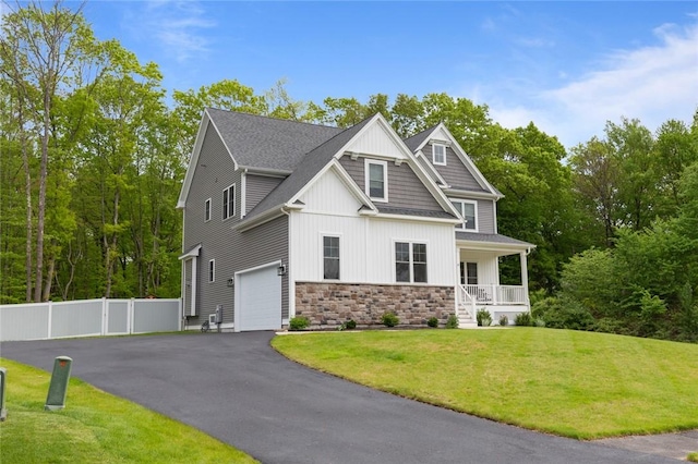 25 Kristin Dr, Cranston, RI 02921 - craftsman house featuring an attached garage, covered porch, board and batten siding, stone siding, and driveway