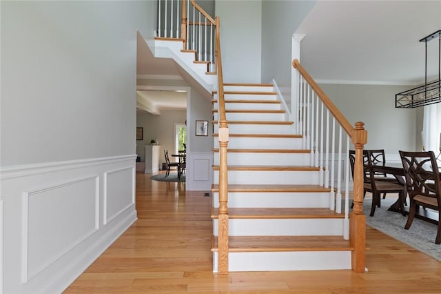25 Kristin Dr, Cranston, RI 02921 - stairs featuring wood finished floors, a wainscoted wall, crown molding, and a decorative wall
