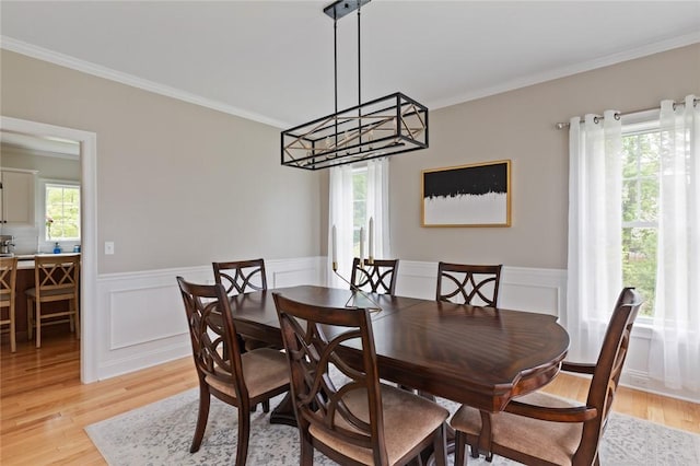 25 Kristin Dr, Cranston, RI 02921 - dining area featuring light wood-style floors, ornamental molding, wainscoting, and a chandelier