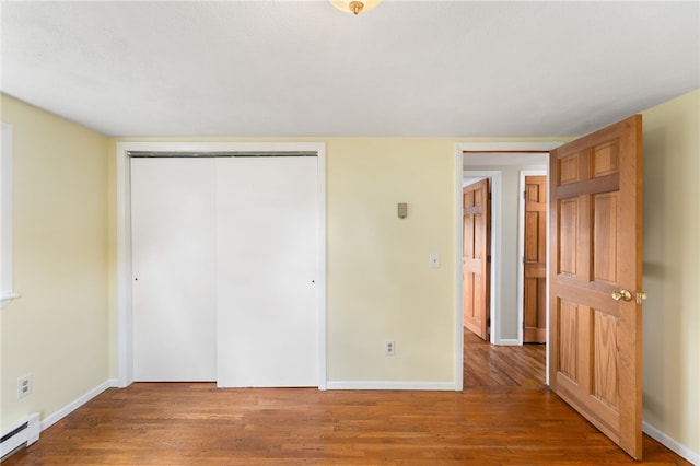 19 Cantara St, West Warwick, RI 02893 - unfurnished bedroom featuring baseboard heating, wood finished floors, and a closet