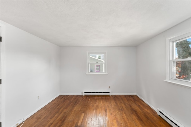 19 Cantara St, West Warwick, RI 02893 - empty room with baseboard heating, a baseboard heating unit, plenty of natural light, and wood-type flooring