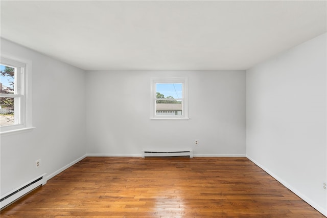 19 Cantara St, West Warwick, RI 02893 - empty room with a baseboard heating unit, a baseboard radiator, plenty of natural light, and wood finished floors