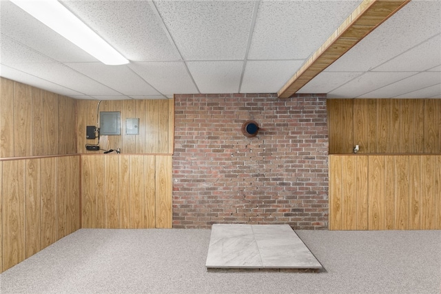 19 Cantara St, West Warwick, RI 02893 - miscellaneous room with wood walls, carpet flooring, a paneled ceiling, and brick wall