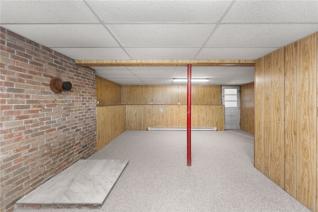 19 Cantara St, West Warwick, RI 02893 - below grade area with wood walls, a drop ceiling, carpet flooring, brick wall, and baseboard heating
