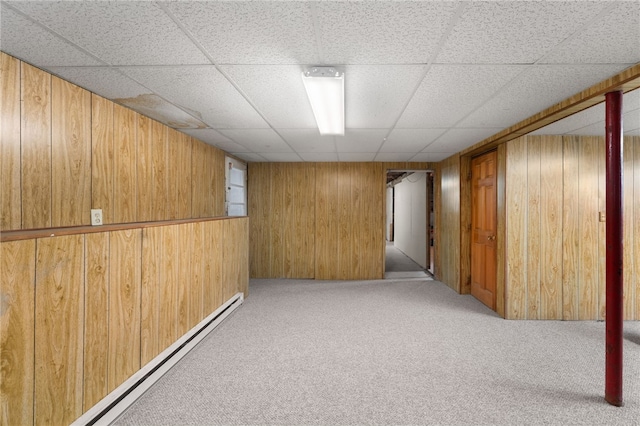 19 Cantara St, West Warwick, RI 02893 - finished basement featuring carpet flooring, wood walls, a baseboard heating unit, and a drop ceiling