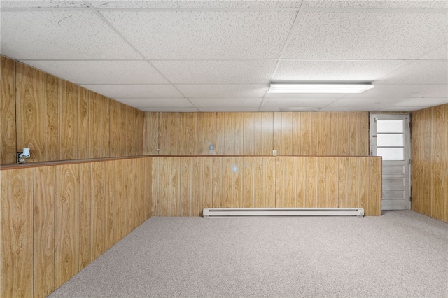 19 Cantara St, West Warwick, RI 02893 - below grade area featuring wood walls, carpet flooring, a baseboard heating unit, and a drop ceiling