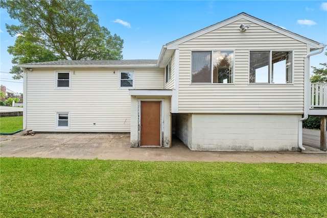 19 Cantara St, West Warwick, RI 02893 - rear view of property with a lawn and a patio