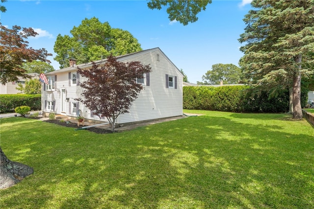 19 Cantara St, West Warwick, RI 02893 - view of side of home with a lawn and a chimney