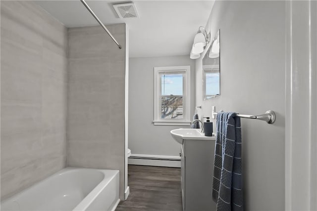 40 Jenkins St, Providence, RI 02906 - full bath with a baseboard radiator, vanity, wood finished floors, and shower / bath combination