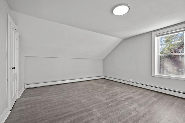 40 Jenkins St, Providence, RI 02906 - additional living space with lofted ceiling, a baseboard heating unit, and wood finished floors