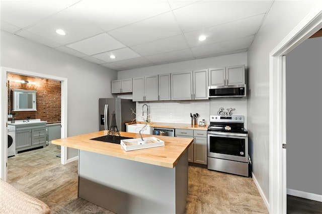 1117 Douglas Ave Unit 124, North Providence, RI 02904 - kitchen with stainless steel appliances, wooden counters, gray cabinets, decorative backsplash, and recessed lighting
