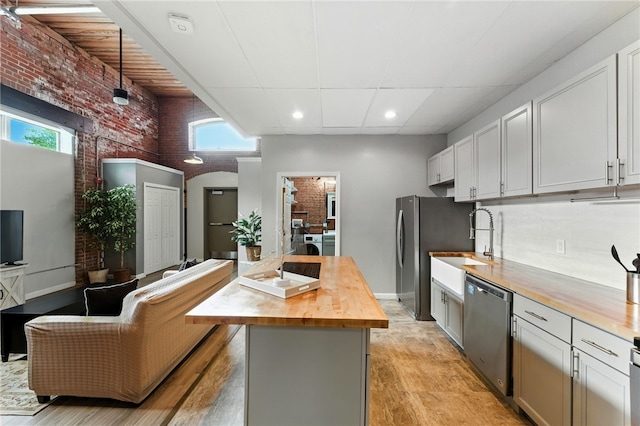1117 Douglas Ave Unit 124, North Providence, RI 02904 - kitchen with brick wall, wood counters, appliances with stainless steel finishes, light wood finished floors, and recessed lighting