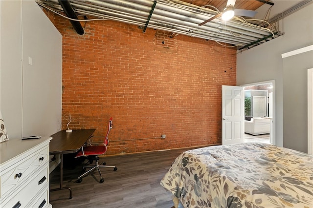 1117 Douglas Ave Unit 124, North Providence, RI 02904 - bedroom featuring a towering ceiling, wood finished floors, brick wall, and an office area