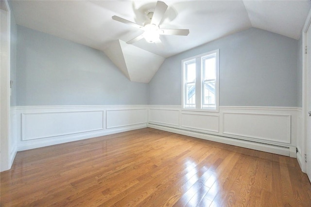 193 Howell St Unit 3, Providence, RI 02906 - additional living space with a baseboard heating unit, lofted ceiling, wood finished floors, and a wainscoted wall