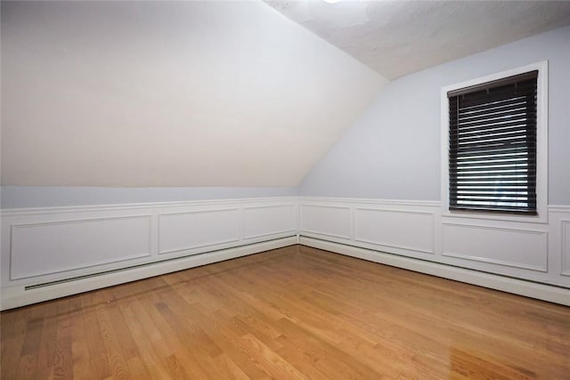 193 Howell St Unit 3, Providence, RI 02906 - bonus room featuring vaulted ceiling, light wood-style floors, a decorative wall, and wainscoting