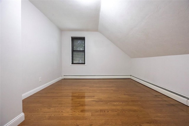 193 Howell St Unit 3, Providence, RI 02906 - additional living space with lofted ceiling, wood finished floors, and a baseboard heating unit