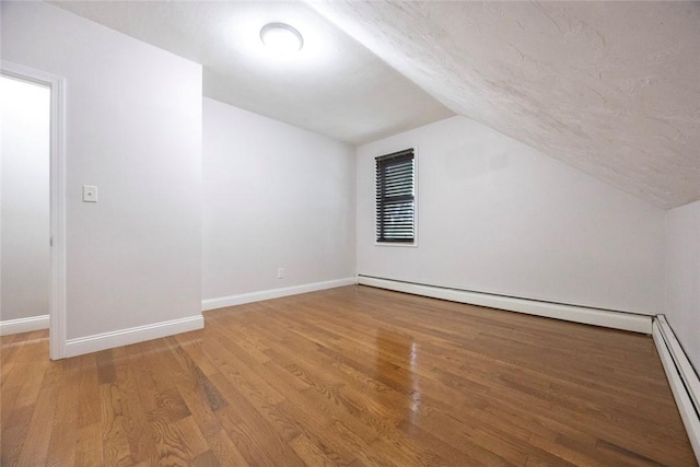 193 Howell St Unit 3, Providence, RI 02906 - bonus room featuring vaulted ceiling, a baseboard radiator, and light wood-style flooring
