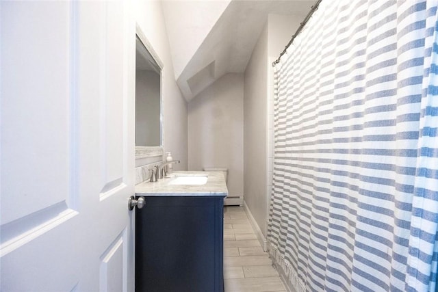 193 Howell St Unit 3, Providence, RI 02906 - bathroom featuring vanity, baseboard heating, and curtained shower