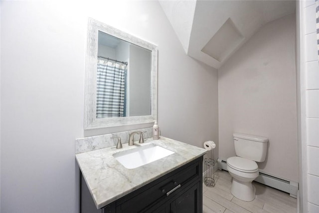 193 Howell St Unit 3, Providence, RI 02906 - bathroom with baseboard heating, vanity, vaulted ceiling, and wood finished floors