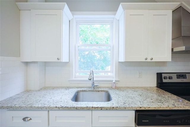 193 Howell St Unit 3, Providence, RI 02906 - kitchen with wall chimney range hood, white cabinets, dishwashing machine, and tasteful backsplash