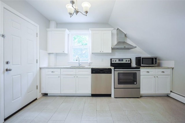 193 Howell St Unit 3, Providence, RI 02906 - kitchen featuring stainless steel appliances, wall chimney exhaust hood, a chandelier, white cabinets, and decorative light fixtures