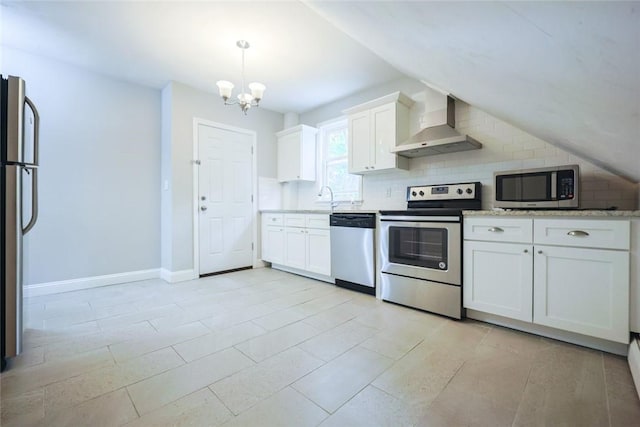 193 Howell St Unit 3, Providence, RI 02906 - kitchen with appliances with stainless steel finishes, wall chimney range hood, a chandelier, white cabinetry, and backsplash