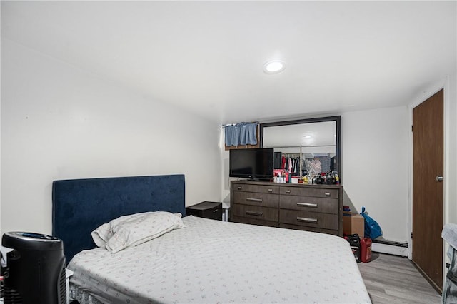 236 Vermont Ave, Providence, RI 02905 - bedroom with light wood-style floors and a baseboard heating unit