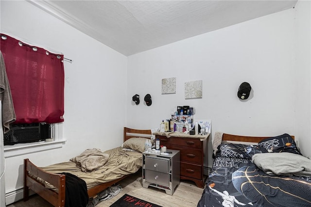 236 Vermont Ave, Providence, RI 02905 - bedroom with light wood-style floors, a baseboard heating unit, and cooling unit