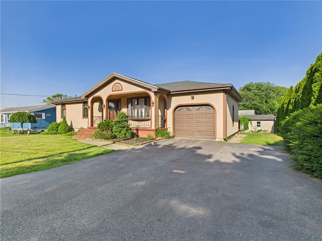 128 Arbor Ter, Tiverton, RI 02878 - single story home with an attached garage, a front yard, driveway, stucco siding, and covered porch