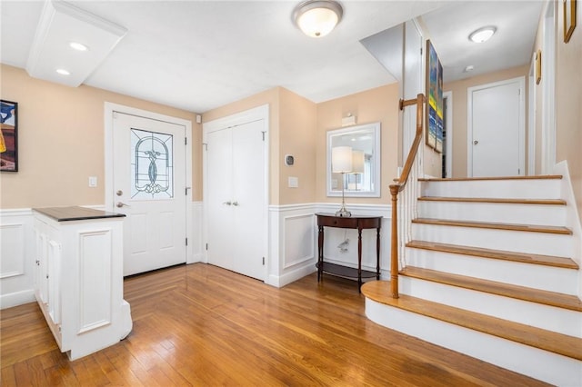 57 Hillside Rd, Lincoln, RI 02865 - foyer with a wainscoted wall, stairway, wood finished floors, and a decorative wall