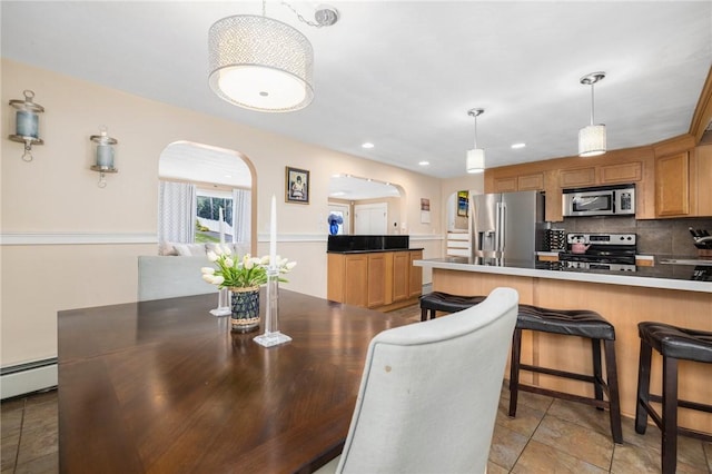 57 Hillside Rd, Lincoln, RI 02865 - dining room featuring arched walkways, baseboard heating, and recessed lighting