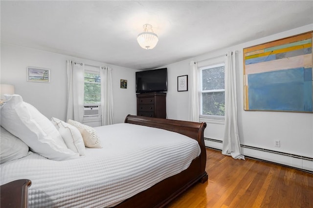 57 Hillside Rd, Lincoln, RI 02865 - bedroom with wood finished floors, a baseboard radiator, and cooling unit