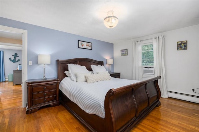 57 Hillside Rd, Lincoln, RI 02865 - bedroom with wood finished floors, a baseboard radiator, cooling unit, and a baseboard heating unit