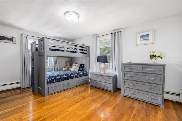 57 Hillside Rd, Lincoln, RI 02865 - bedroom featuring baseboard heating and light wood-style floors